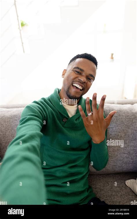 Portrait Of Happy African American Gay Man Showing Wedding Ring While