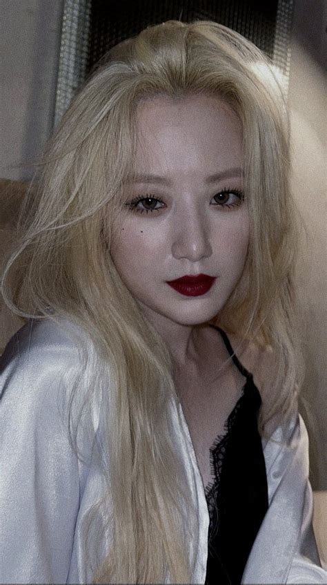 a woman with long blonde hair and red lipstick