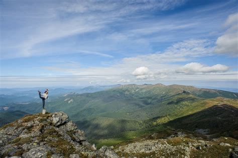 Premium Photo | Young woman practices yoga on a mountain top