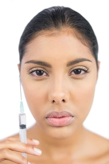 Premium Photo Serious Nude Brunette Holding Injection