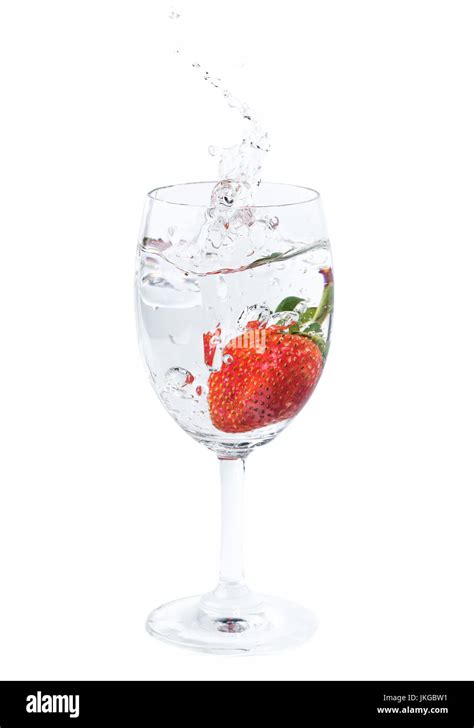 Fresh Strawberry Dropped Into Water In Wine Glass With Splash On White