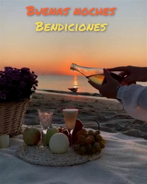 A Person Pouring Wine Into A Basket On The Beach At Sunset With Flowers