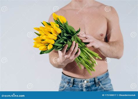 Man Man With Naked Torso Gives Flowers Romantic Man With Bouquet Of Tulips For Birthday Happy