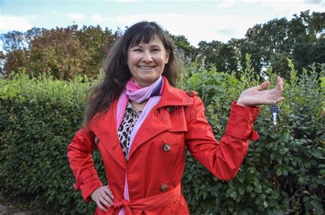 Cute Smiling Brunette Girl Showing Bunch Of House Keys In A Hand Towards The Camera Stock Image
