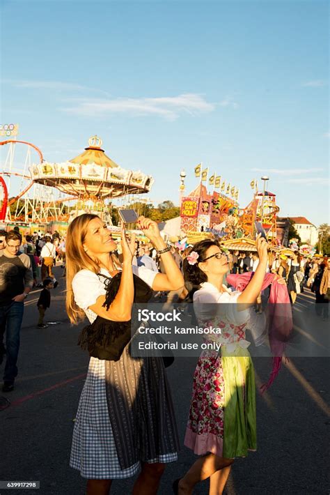 Women In Dirndl Taking Photo At The Oktoberfest Stock Photo - Download ...