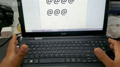 Someone Is Typing On Their Laptop With The Screen Turned Off And Black