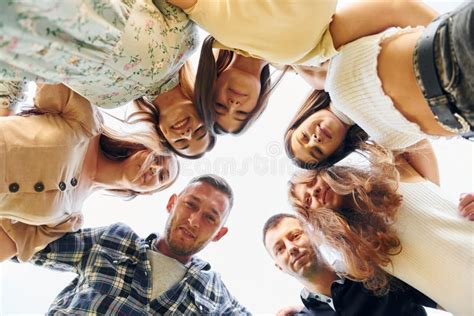 View From Below Of Young Positive People That Looking Down Stock Image