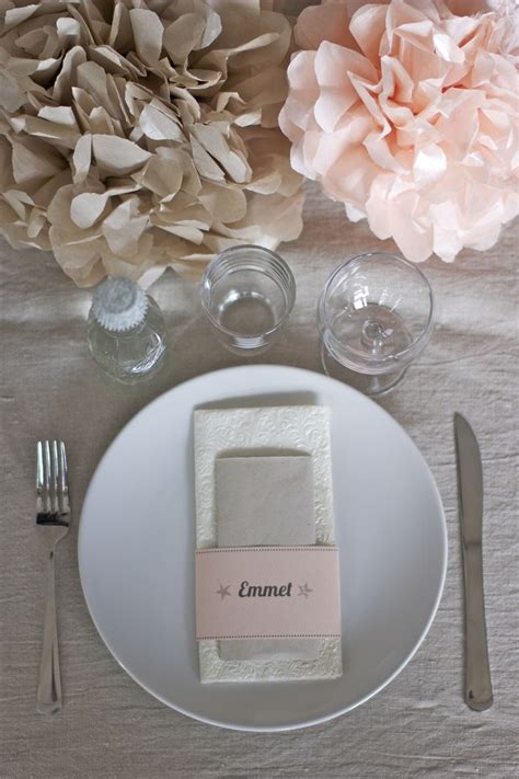 A Place Setting With Napkins Silverware And Flowers