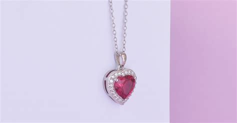 A Silver Necklace with a Heart Shaped Pendant · Free Stock Photo