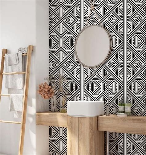 the bathroom is decorated with black and white geometric wallpaper ...