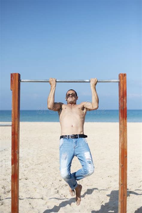 A Male Athlete With A Naked Torso Is Training On A Horizontal Bar Stock Image Image Of Hand