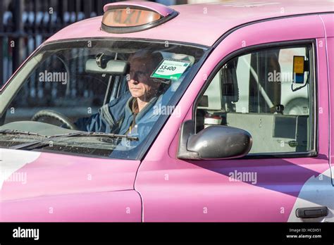 A Mature Male Taxi Driver Sitting In Traffic In His Pink Cab The Sign Reads For Hire So He Is