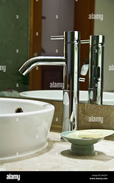 Silver Chrome Bathroom Tap Faucets Running Water In A Sink Stock Photo