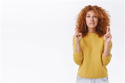 Free Photo Redhead Woman With Curly Hair In Yellow Sweater Pointing