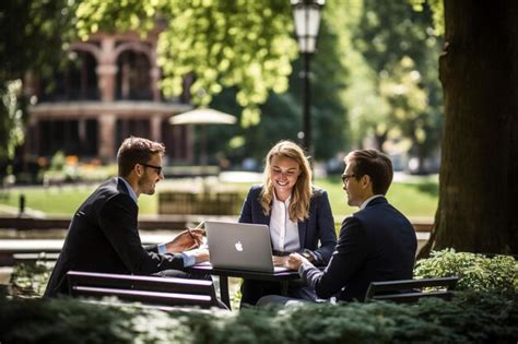 Premium Photo | Business people with laptop talking in city park