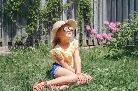 Premium Photo Girl Sitting In Grass At Yard