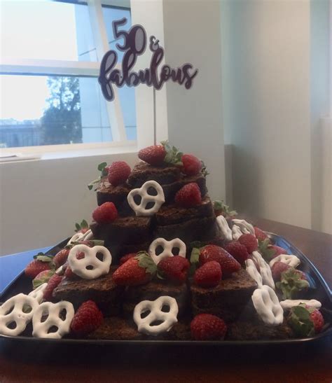 A Chocolate Cake With Strawberries And Pretzels On Top