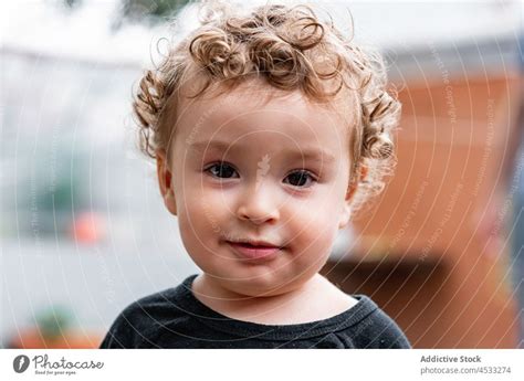 Cute little boy with curly hair - a Royalty Free Stock Photo from Photocase