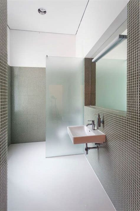 A Stylish Minimalist Bathroom With Grey Tiles And White Grout And A