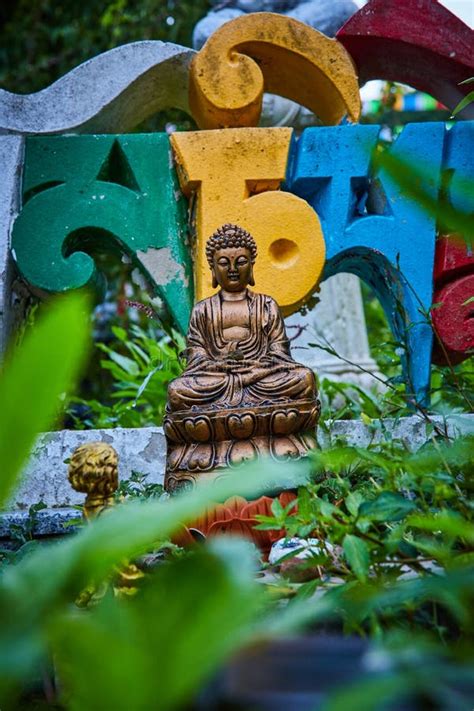 Garden Plants Surround Buddha Statue and Colorful Lettering Editorial ...