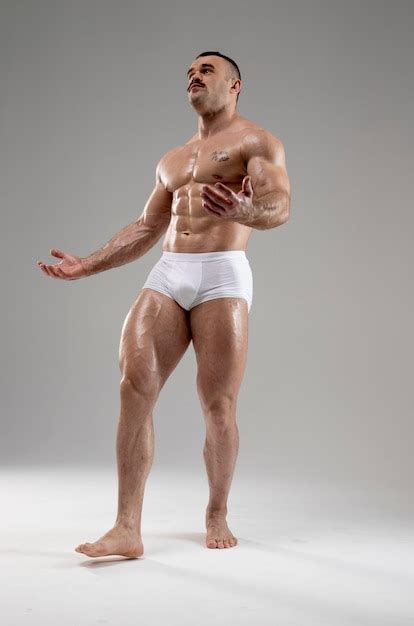 Premium Photo Full Length Portrait Of Attractive Muscled Naked Man Posing Raised Hands Up In