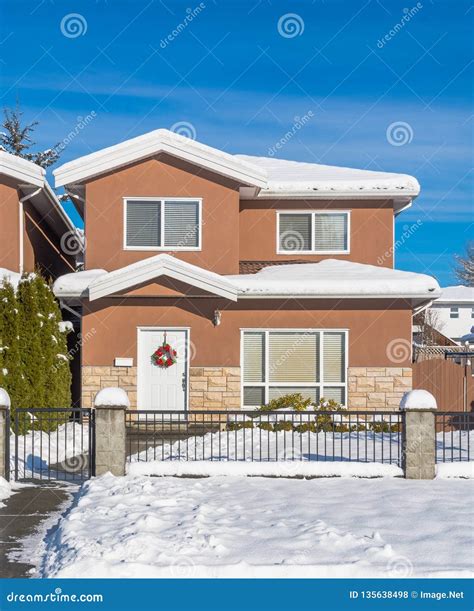 A Typical American House in Winter. Snow Covered House Stock Photo