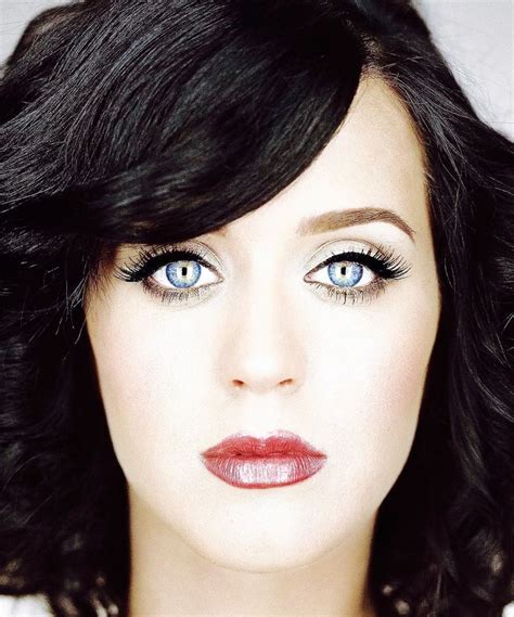 a woman with dark hair and blue eyes