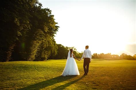 Premium Photo Happy Bride And Groom Go Into The Sunset Lovely Wedding