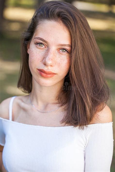 Young Beautiful Brown-haired Girl with Freckles on Her Face Stock Image ...