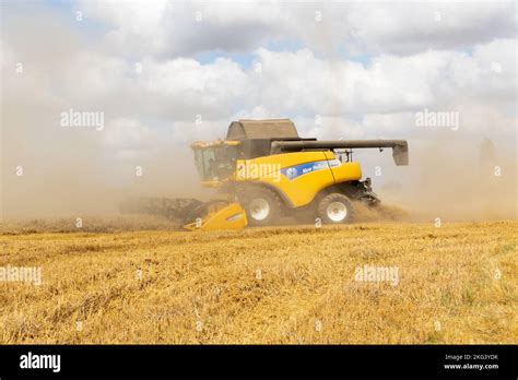 Combine Harvester Creating A Dust Cloud Stock Photo Alamy
