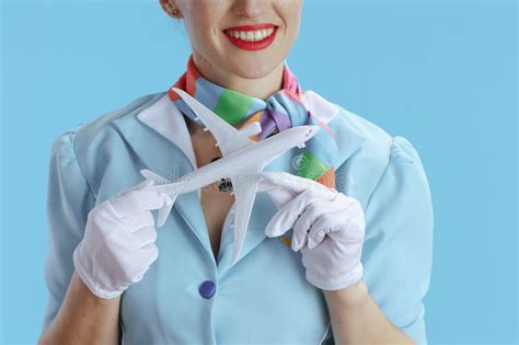 Closeup On Smiling Stylish Female Flight Attendant On Blue Stock Image