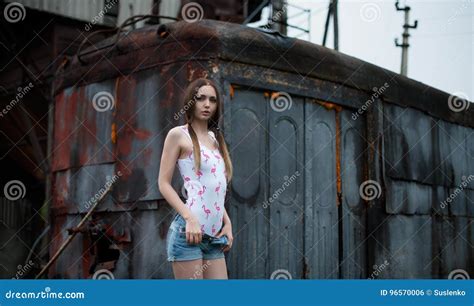 Young Girl Undresses On A Background Of Getting Together In The Style Of Post Apocalypse Stock