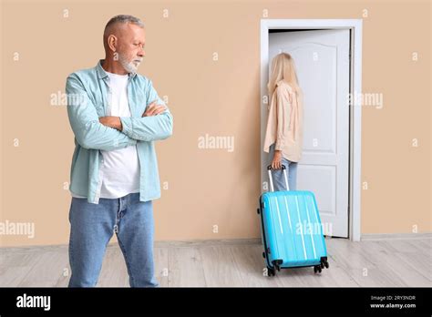 Mature Woman With Suitcase Leaving Her Husband At Door Divorce Concept Stock Photo Alamy