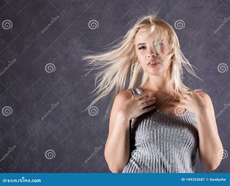 Blonde Woman With Hair In The Wind Girl With Flying Hair On A Gray Background Stock Image