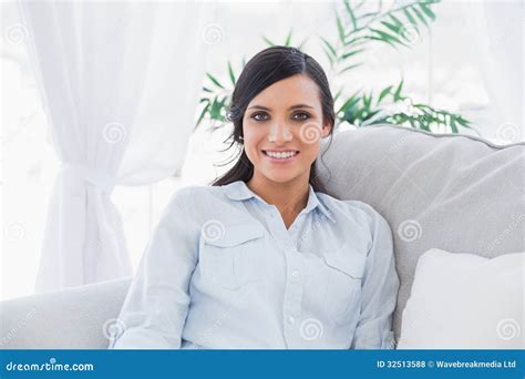 Happy Brunette Sitting On The Couch Stock Photo Image Of Brunette Apartment 32513588