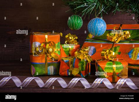 Many Christmas Presents Under The Tree With Decorations And Ribbon