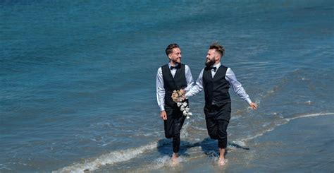 Premium Photo Gay Grooms Walking Together On Sea Beach During Wedding Day Romantic Men In Sea