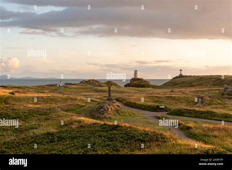 The Llanddwyn island lighthouse, Twr Mawr at Ynys Llanddwyn on Anglesey, North Wales at sunset ...