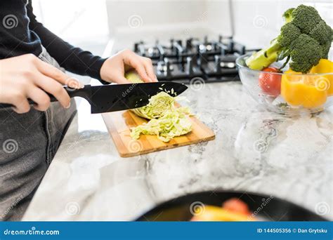 Woman Hands Cutting Vegetables For Salad In The Kitchen Close Up Stock