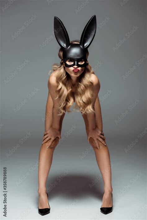 Blonde Woman In Rabbit Mask Looking At Camera On Grey Background Stock Photo Adobe Stock