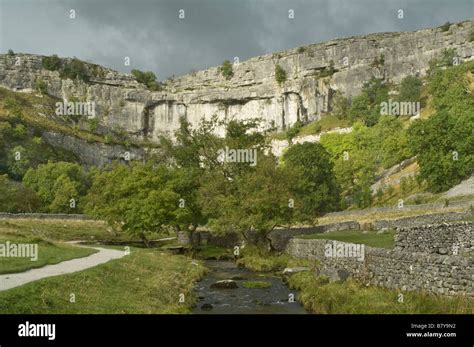 The Limestone Cliff Of Malham Cove In The Yorkshire Dales With A Stormy