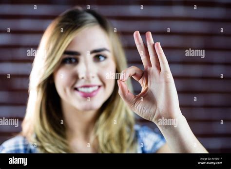 Pretty Blonde Woman Making Signs With Her Fingers Stock Photo Alamy