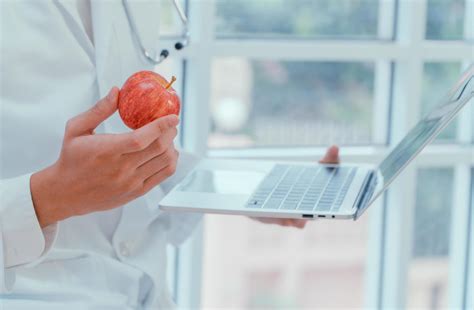 Doctors or nutritionists hold apples and laptops In the clinic To