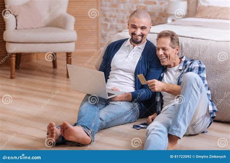 Gay Couple Looking At The Laptop And Having Fun Stock Photo Image Of Devise Floor