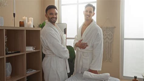 Men Smiling In A Spa Room Wearing Bathrobes Embodying Gay Love And Wellness In A Serene Indoor