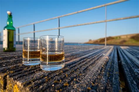 Drinking Single Malt Scotch Whisky At Sunset With Sea Ocean Or River