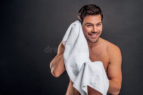A Close Up Photo Of An Attractive Naked Macho Man Wiping His Face With