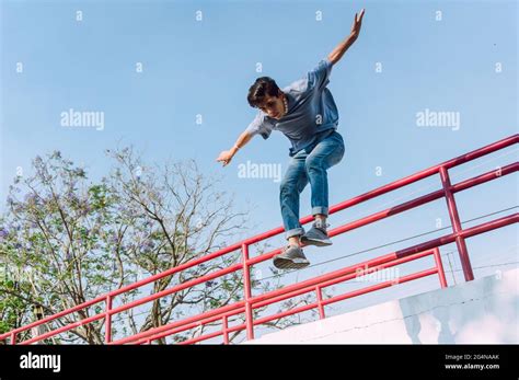 Male Transgender With Naked Torso Covering Face From Sunshine With Outstretched Arms While
