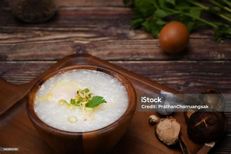 rice porridge  soft boiled egg slice ginger  scallion  wooden