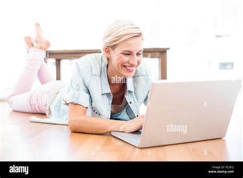Pretty Blonde Woman Lying On The Floor And Using Her Laptop Stock Photo Alamy